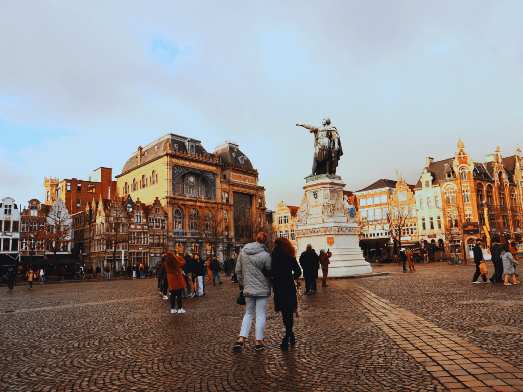 Beeld op de Vrijdagmarkt in Gent van een bekend boegbeeld, het plein en de gebouwen tijdens een stedentrip